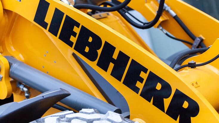 © filmbildfabrik - stock.adobe.com MUNICH / GERMANY - APRIL 14, 2019: Liebherr logo on a digger arm at a Liebherr machine dealer.